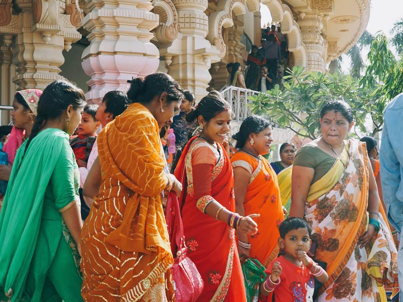 Women in bright saris walking together and laughing