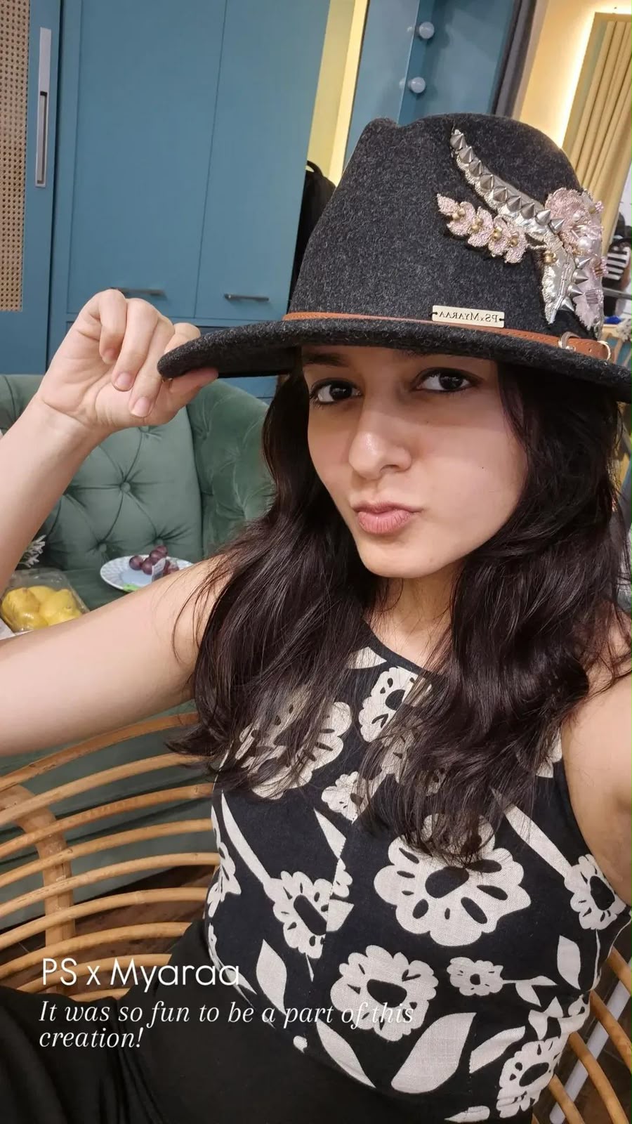 Labdhi Kothari tipping a black felt fedora with silver and pink embellishment from the PS x Myaraa collaboration